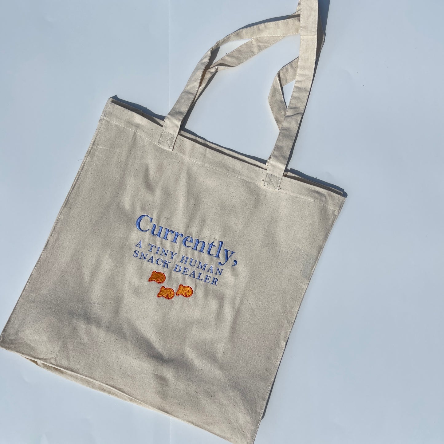 Currently, A Tiny Human Snack Dealer Tote Bag